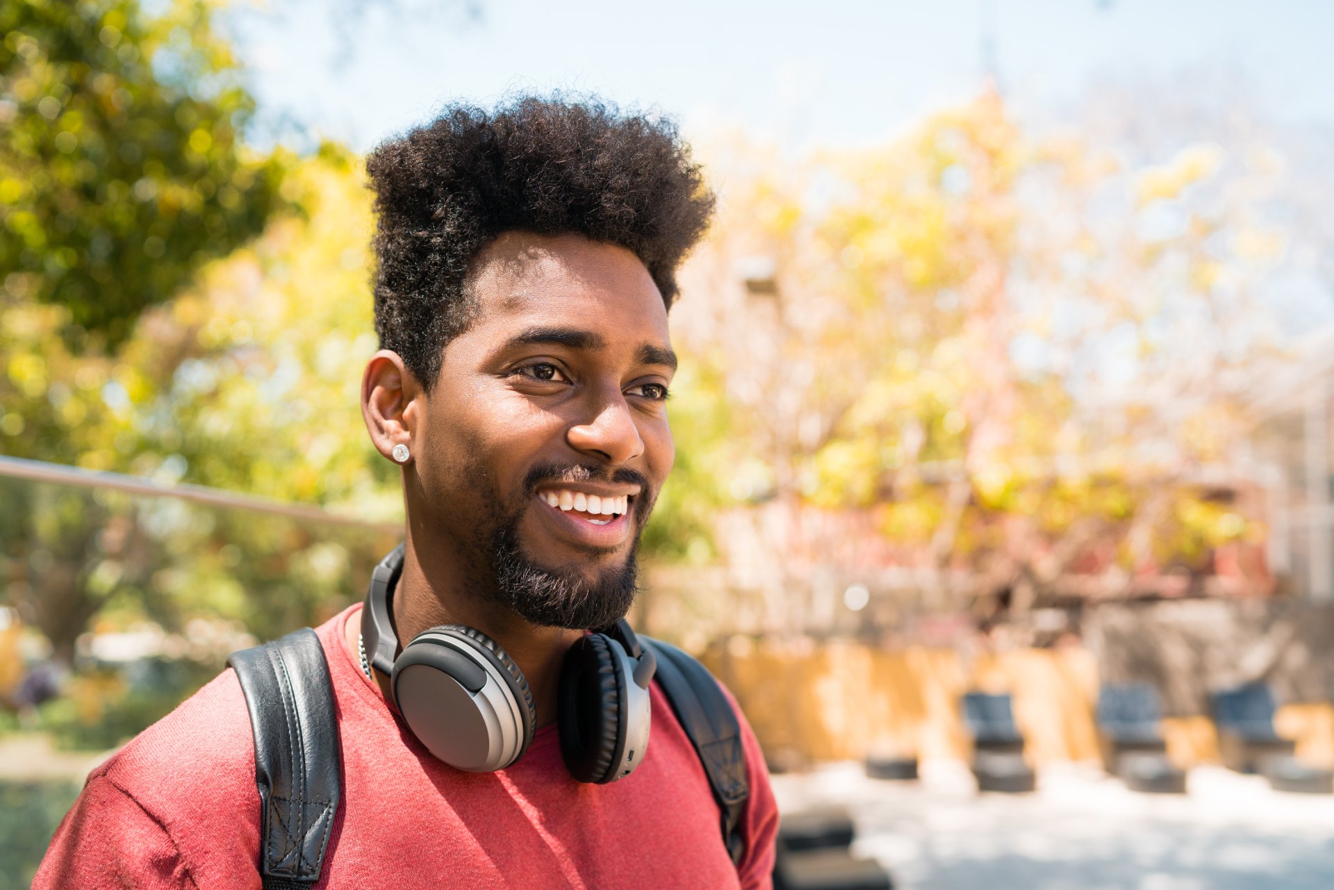 Young afro man listening to music with headphones. Young man with headphones